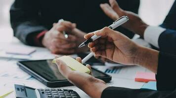 Financial analysts analyze business financial reports on a digital tablet planning investment project during a discussion at a meeting of corporate showing the results of their successful teamwork. video