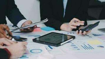 Financial analysts analyze business financial reports on a digital tablet planning investment project during a discussion at a meeting of corporate showing the results of their successful teamwork. video