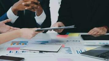 Financial analysts analyze business financial reports on a digital tablet planning investment project during a discussion at a meeting of corporate showing the results of their successful teamwork. video