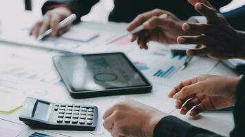 Financial analysts analyze business financial reports on a digital tablet planning investment project during a discussion at a meeting of corporate showing the results of their successful teamwork. video