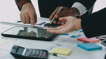 Financial analysts analyze business financial reports on a digital tablet planning investment project during a discussion at a meeting of corporate showing the results of their successful teamwork. video