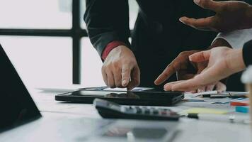 Financial analysts analyze business financial reports on a digital tablet planning investment project during a discussion at a meeting of corporate showing the results of their successful teamwork. video