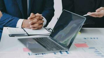 Financial analysts analyze business financial reports on a digital tablet planning investment project during a discussion at a meeting of corporate showing the results of their successful teamwork. video