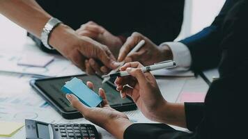 Financial analysts analyze business financial reports on a digital tablet planning investment project during a discussion at a meeting of corporate showing the results of their successful teamwork. video