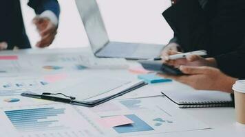 Financial analysts analyze business financial reports on a digital tablet planning investment project during a discussion at a meeting of corporate showing the results of their successful teamwork. video