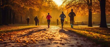 un grupo de corredores corriendo a amanecer en el parque durante otoño. generativo ai. foto