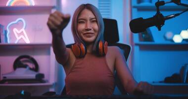 Asian young Esport woman gamer enjoy to play online game on pc photo