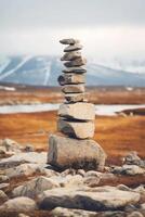 A minimalist Inukshuk made of piled stones pointing the way across the Alaskan tundra. AI generative photo