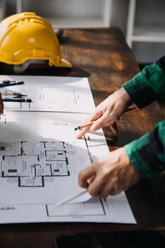 Construction and structure concept of engineer working drawing on blueprint meeting for project working with partner on model building and engineering tools in working site, construction concept. photo