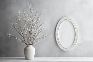 Front view product photo of white oval frame with wild Cotton branches in glass vase behind the frame.
