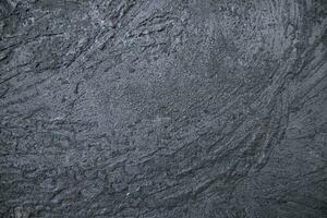 Old metal surface covered black ash abstract background texture photo
