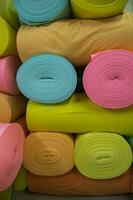 Artistic variety of shade tone colors Textile Fabrics rolls stacked pattern texture photo