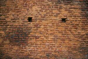 Old historical building brick wall grunge pattern texture can be used as a background wallpaper photo