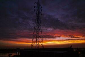 High voltage power line tower with beautiful sky at sunset, stock photo