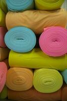 Artistic variety of shade tone colors Textile Fabrics rolls stacked pattern texture photo