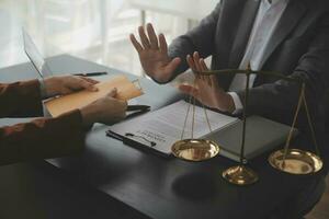 Business and lawyers discussing contract papers with brass scale on desk in office. Law, legal services, advice, justice and law concept picture with film grain effect photo