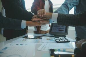 Large business team showing unity with their hands together photo