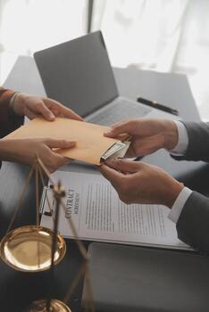 Justice and law concept.Male judge in a courtroom with the gavel, working with, computer and docking keyboard, eyeglasses, on table in morning light photo