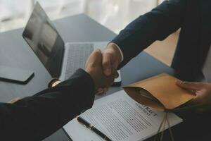 Business and lawyers discussing contract papers with brass scale on desk in office. Law, legal services, advice, justice and law concept picture with film grain effect photo