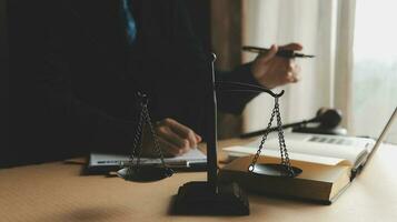 Business and lawyers discussing contract papers with brass scale on desk in office. Law, legal services, advice, justice and law concept picture with film grain effect photo