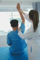 Patient doing some special exercises under supervision in a room photo