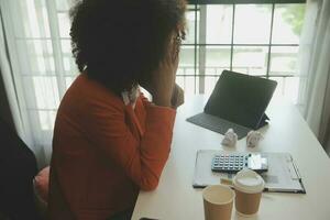 Portrait of Asian young female working on laptop at office photo