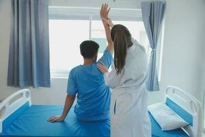 Patient doing some special exercises under supervision in a room photo