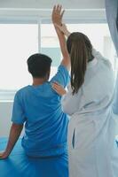 Patient doing some special exercises under supervision in a room photo