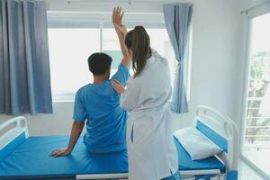 Patient doing some special exercises under supervision in a room photo