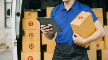 Starting small businesses SME owners man entrepreneurs working, box and check online orders to prepare to pack the boxes, sell to customers, sme business ideas online. photo