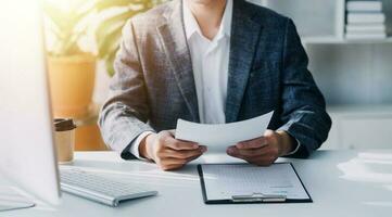 Audit concept,Administrator business man financial inspector and secretary making report calculating balance. Internal Revenue Service checking document. photo