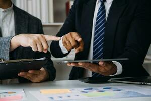 Audit concept,Administrator business man financial inspector and secretary making report calculating balance. Internal Revenue Service checking document. photo