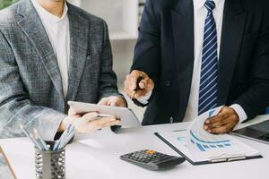 Audit concept,Administrator business man financial inspector and secretary making report calculating balance. Internal Revenue Service checking document. photo