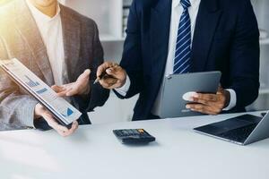 Audit concept,Administrator business man financial inspector and secretary making report calculating balance. Internal Revenue Service checking document. photo