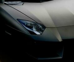 Closeup of Sleek Exotic Black sports car, Wallpaper Crisp Quality photo