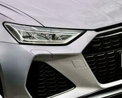 Closeup of Sleek Luxury Sports Car Reflective in Lighting photo