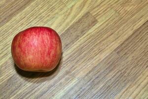 red apples, fresh fruit just picked from the tree on the table photo