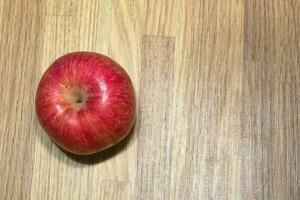 red apples, fresh fruit just picked from the tree on the table photo