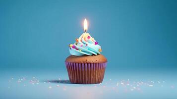 Birthday cupcake with a candle on light blue background with balloons. photo