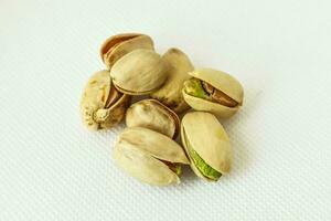 Pistachio nuts on white background. Healthy food concept. photo