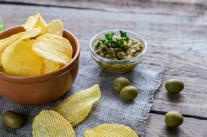 Potato chips with olive tapenade photo