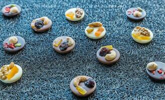 Swiss chocolate candies with nuts and dried fruits photo