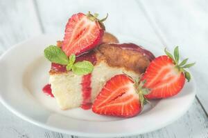 Slice of cheesecake with fresh strawberries photo