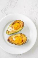 Baked eggs in avocado photo