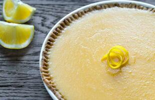 Lemon tart on the wooden background photo