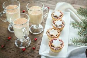 Glasses of eggnog with mince pies photo