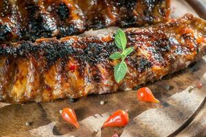 Grilled pork ribs on the wooden board photo