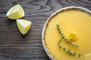 Lemon tart on the wooden background photo