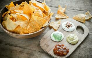 Cheese nachos with different types of sauce photo