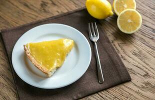 Slice of lemon tart on the plate photo